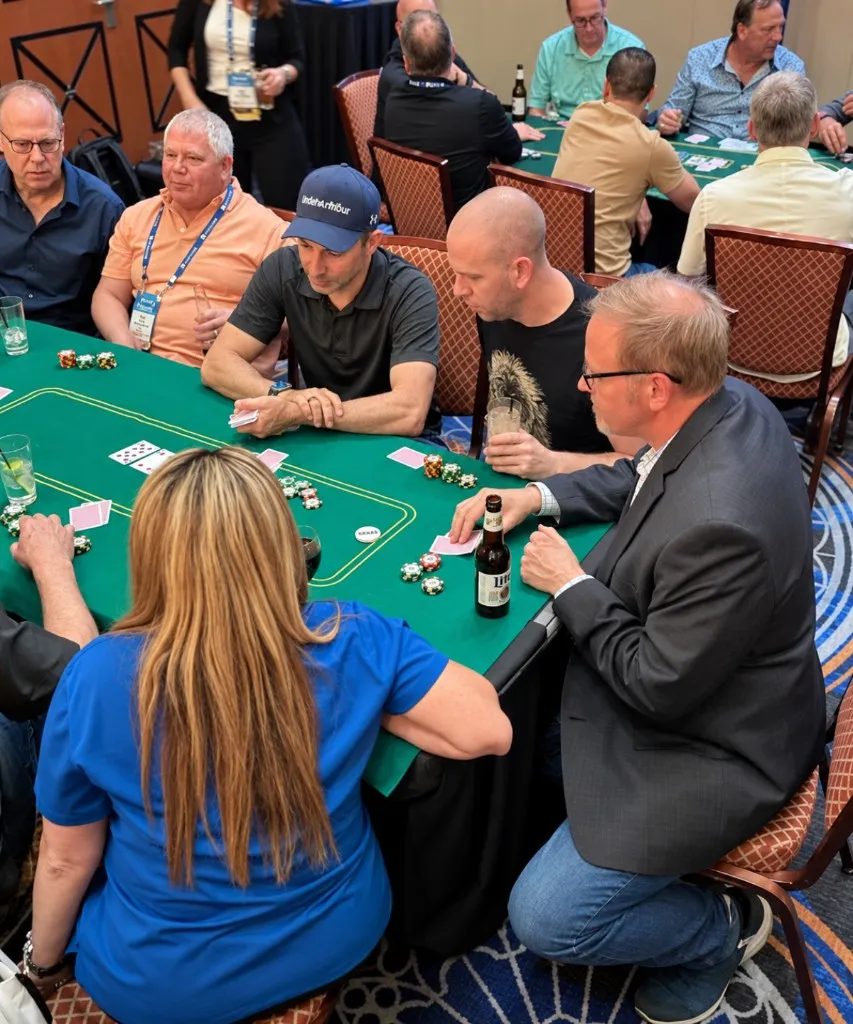 Corporate poker event guests playing hands after their professional poker lesson.