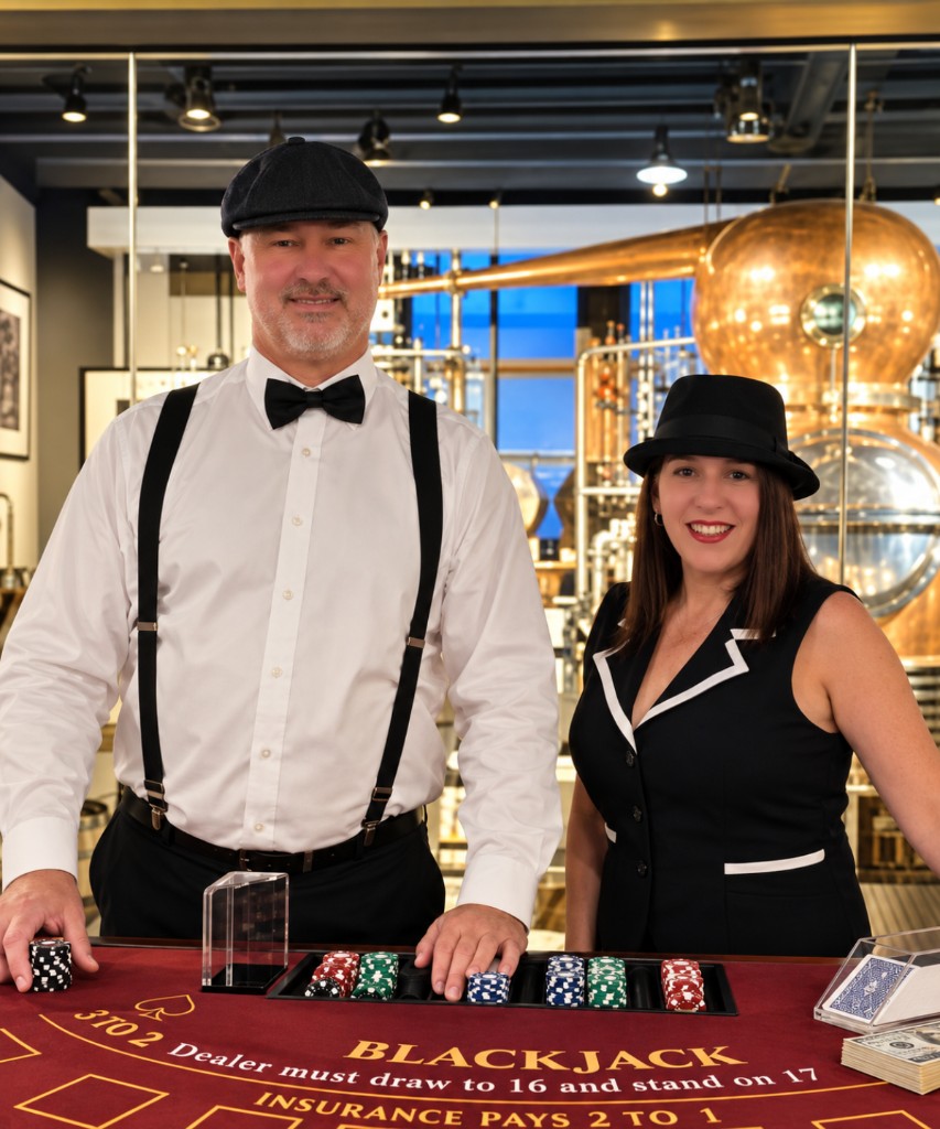 Casino-night dealers standing ready at a poker table for a corporate event.