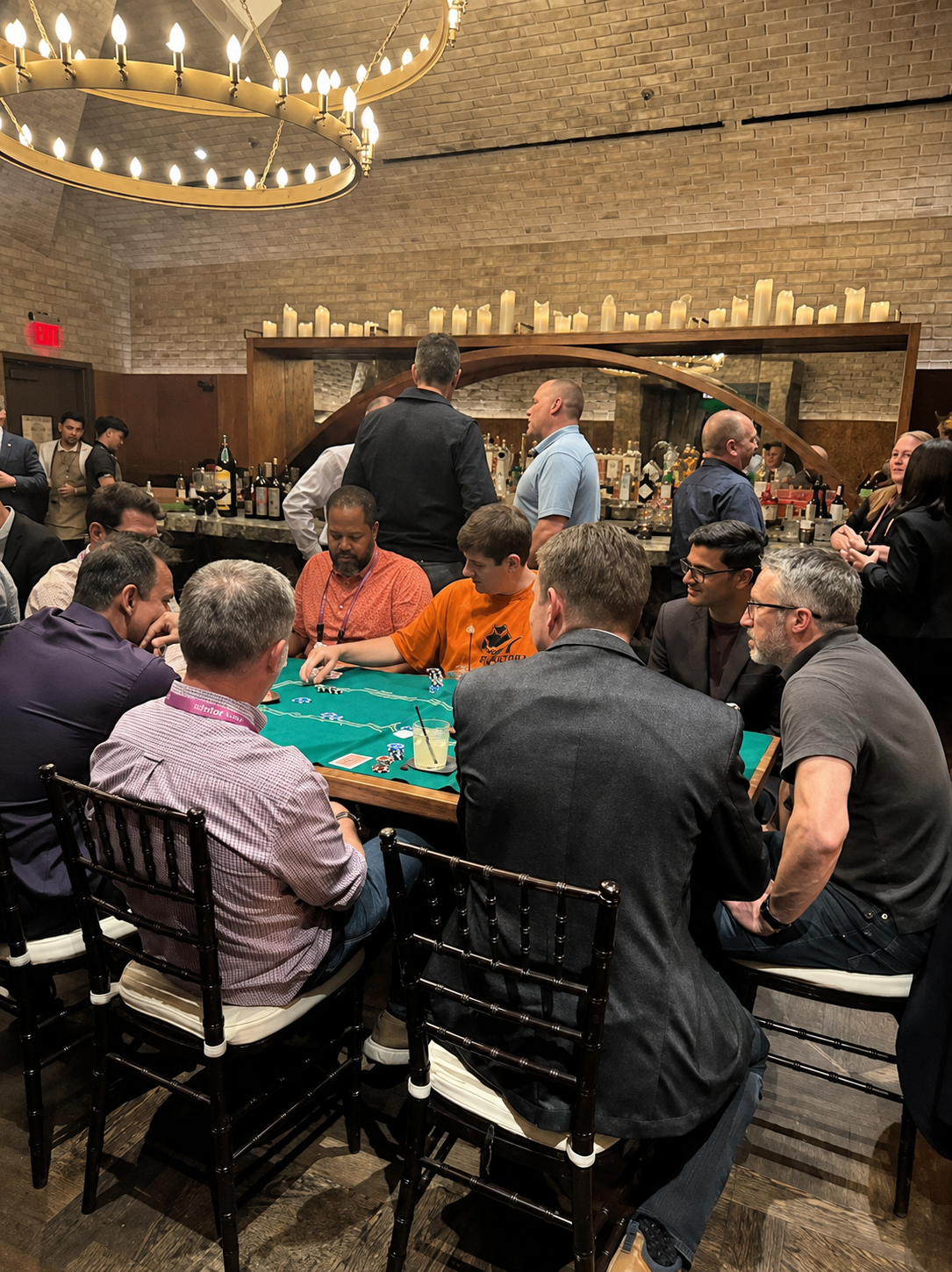 Corporate event guests gathered around poker tables during a private experience.